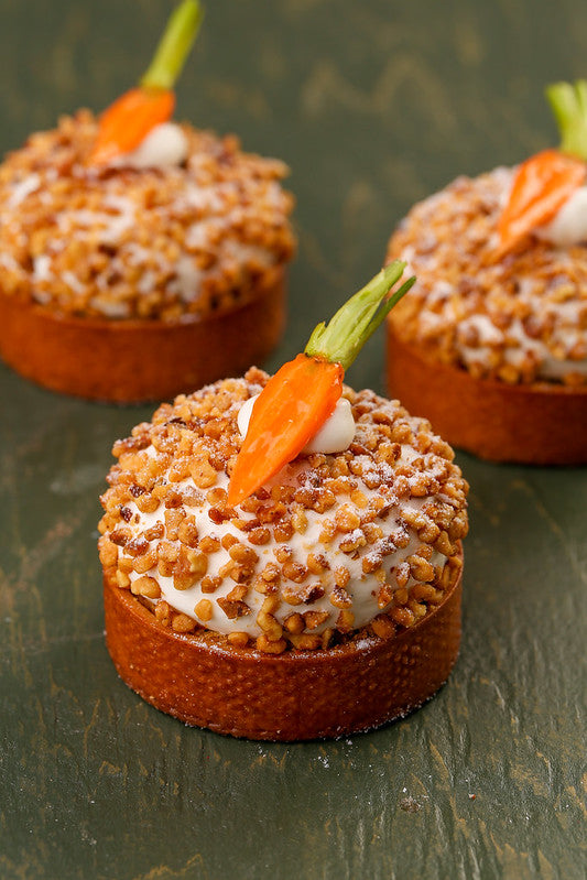 Three tartlets coated with chopped nuts and decorated with small carrot halves - KICA books 